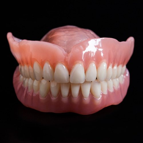 Close-up of full dentures in Hackensack, NJ on black background