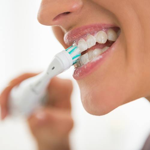 Close-up of woman brushing her teeth