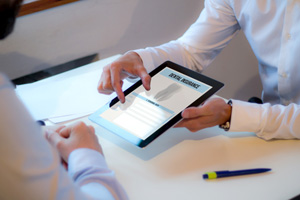 Patient reviewing dental insurance form on tablet