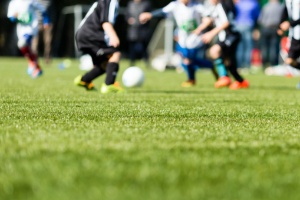 Teens playing soccer risking a knocked out tooth