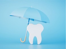 Tooth pictured under blue umbrella 