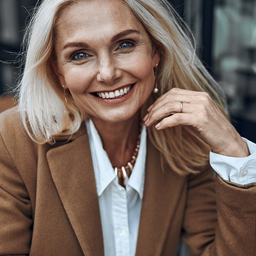 Smiling woman enjoying the benefits of dental implants