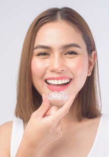 patient holding clear aligners 