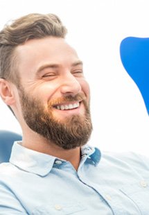 patient smiling in dental mirror