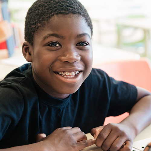 Smiling teen with traditional orthodontics