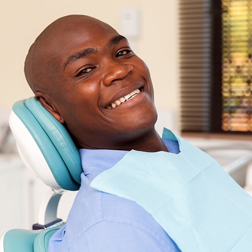 Man smiling after receiving one visit dental restoration