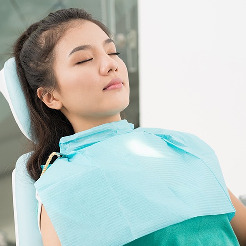 Woman relaxing under oral conscious dental sedation