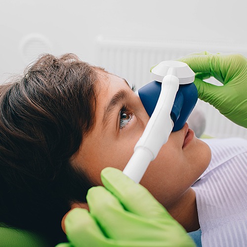 Child receiving nitrous oxide sedation dentistry treatment