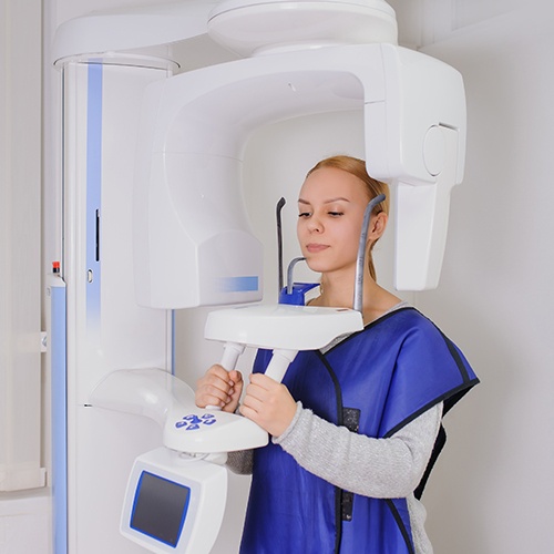 Dental patient receiving 3 D cone beam imaging scans