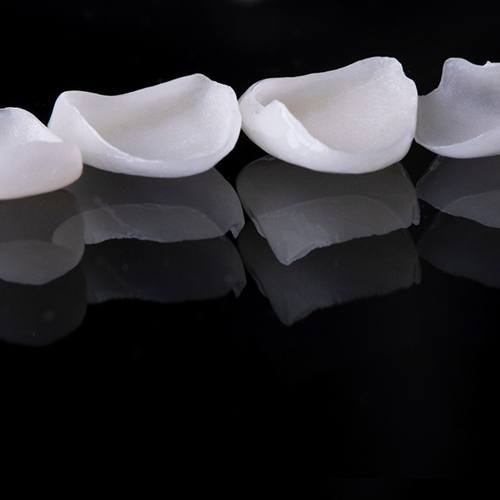 Four veneers in Hackensack, NJ on a black surface