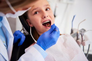 a child smiling while visiting their orthodontist 