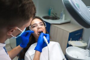 Woman with brown hair undergoing a root canal