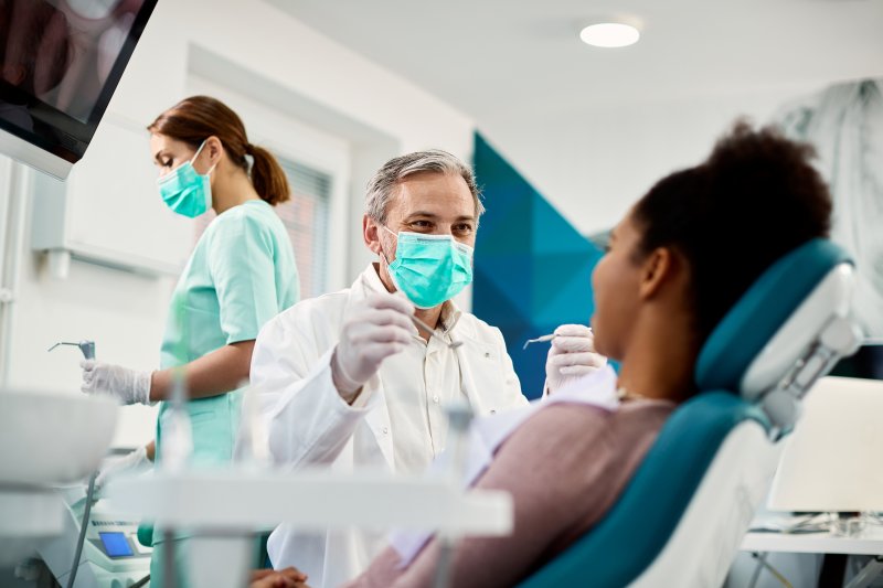 Dentist treats patient