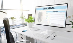 Dental insurance form on a large desktop monitor